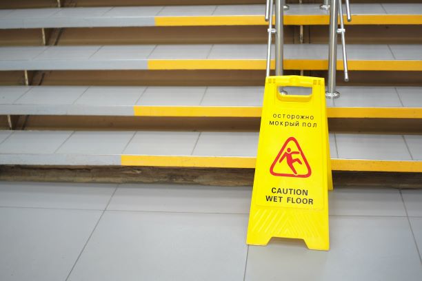 Caution Wet Floor sign in front of a staircase