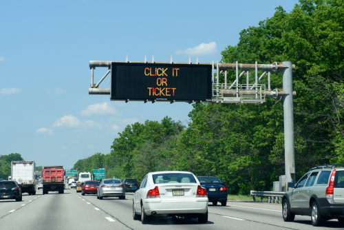 Variable message sign overhead with the words "click it or ticket".