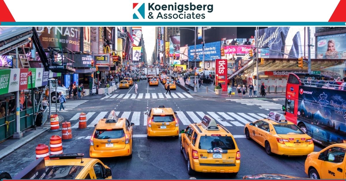 Busy new york street, including cars, busses, and pedestrians crossing