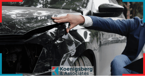 insurance adjuster examining car after accident