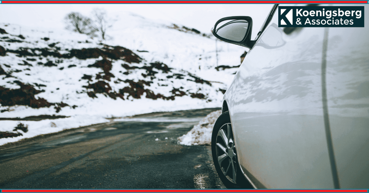 Car avoiding mound of snow on road,