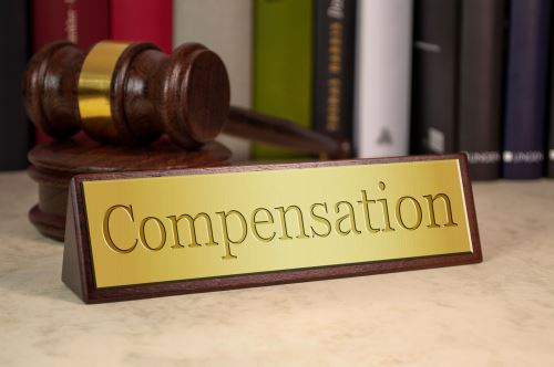 A placard on a desk saying "Compensation"