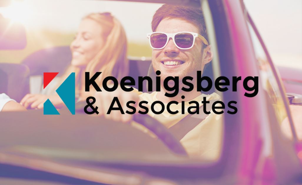 Man driving a woman, Koenigsberg & Associates logo overlayed
