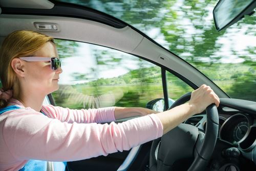 Woman driving, wearing sunglasses