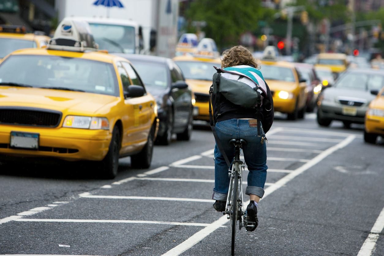 cyclist riding the opposite direction in traffic