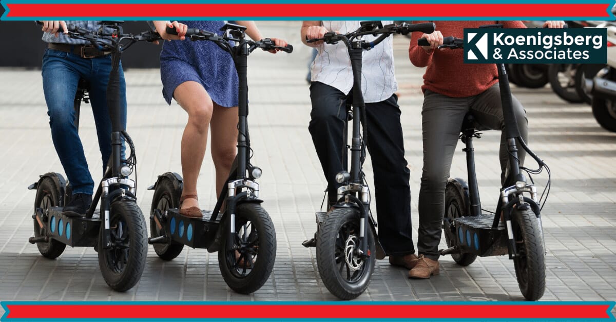 Folks lined up next to each other on e-scooter