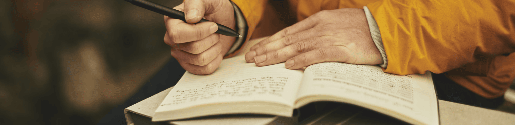 Backpacker Writing in his Journal