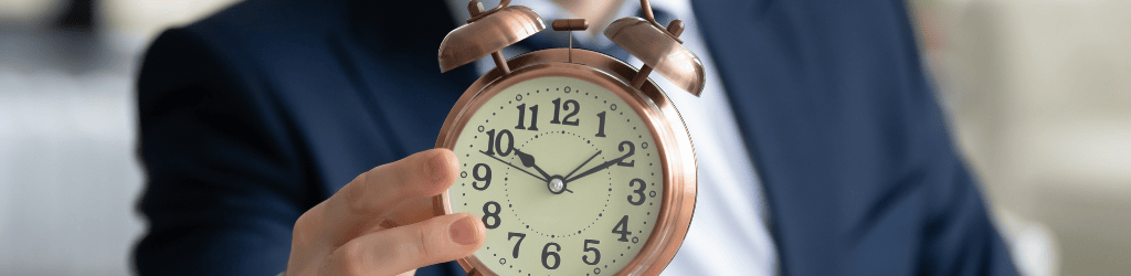 Close up of businessman hold clock showing time limit